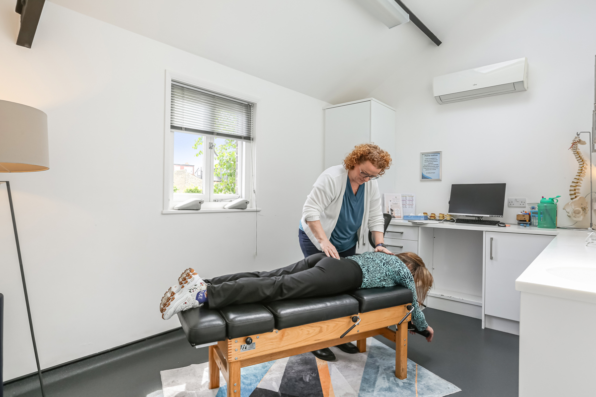 Dr Kelly treating a patient with back pain at Kingston Chiropractic & Wellness Centre