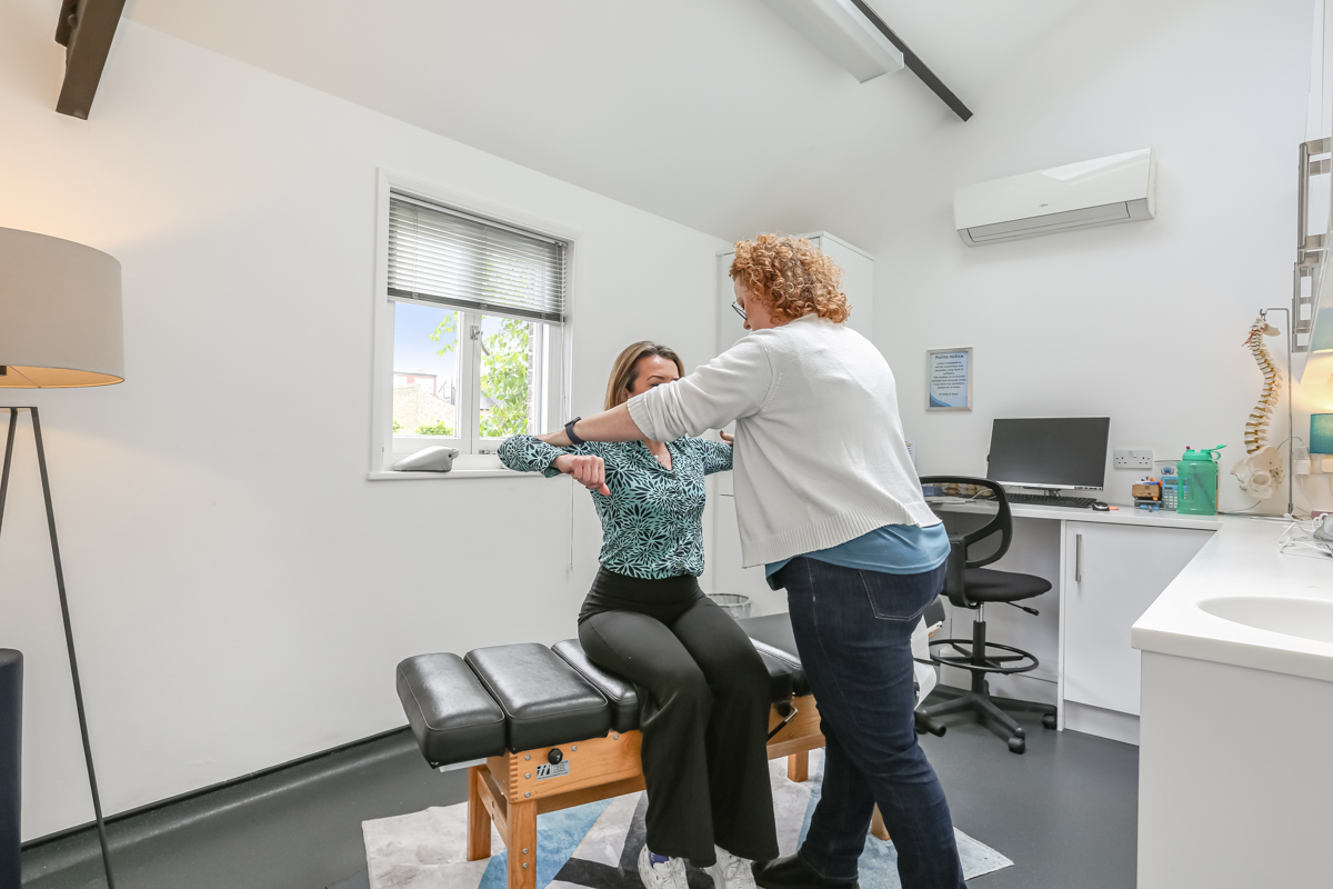 Dr Kelly assessing a patient at Kingston Chiropractic & Wellness Centre
