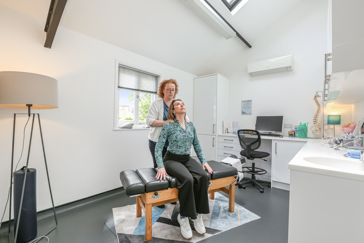 Dr Kelly providing chiropractic neck treatment at Kingston Chiropractic & Wellness Centre