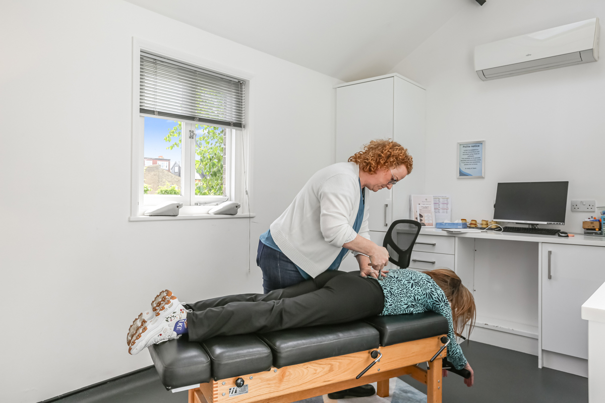 Dr Kelly performing a spinal adjustment at Kingston Chiropractic